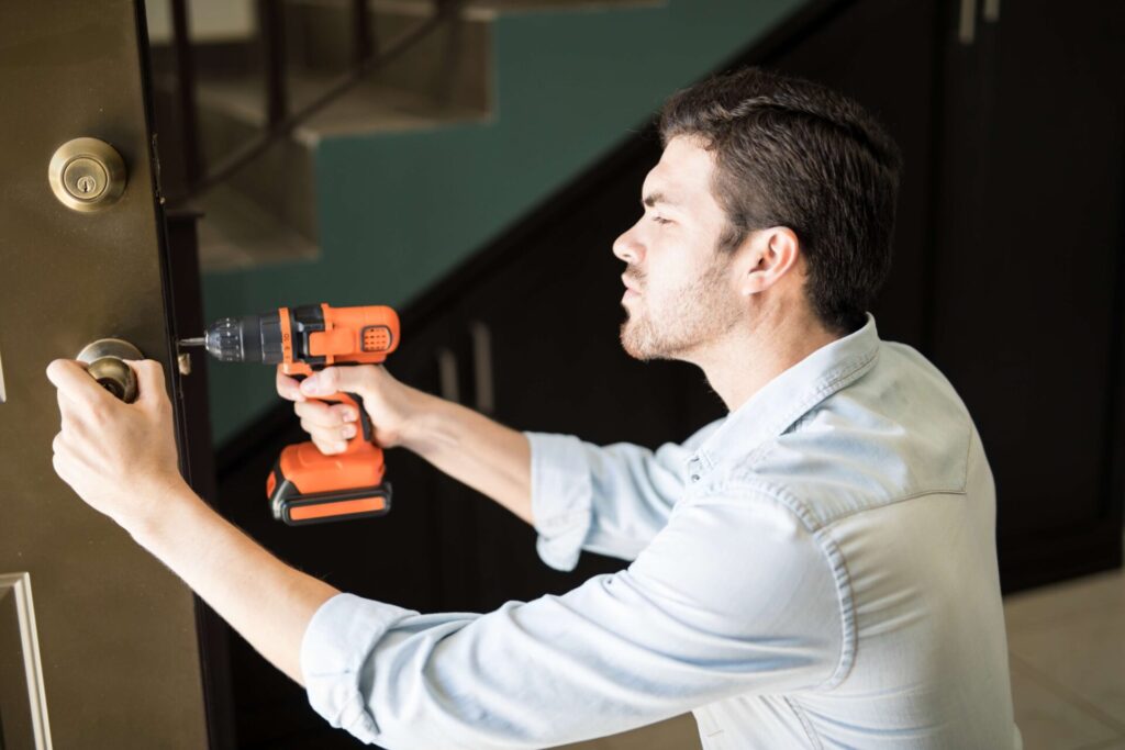handyman-fixing-a-door-knob-2026-03-25-09-15-29-utc_compressed Mobile locksmith using a drill on a door lock